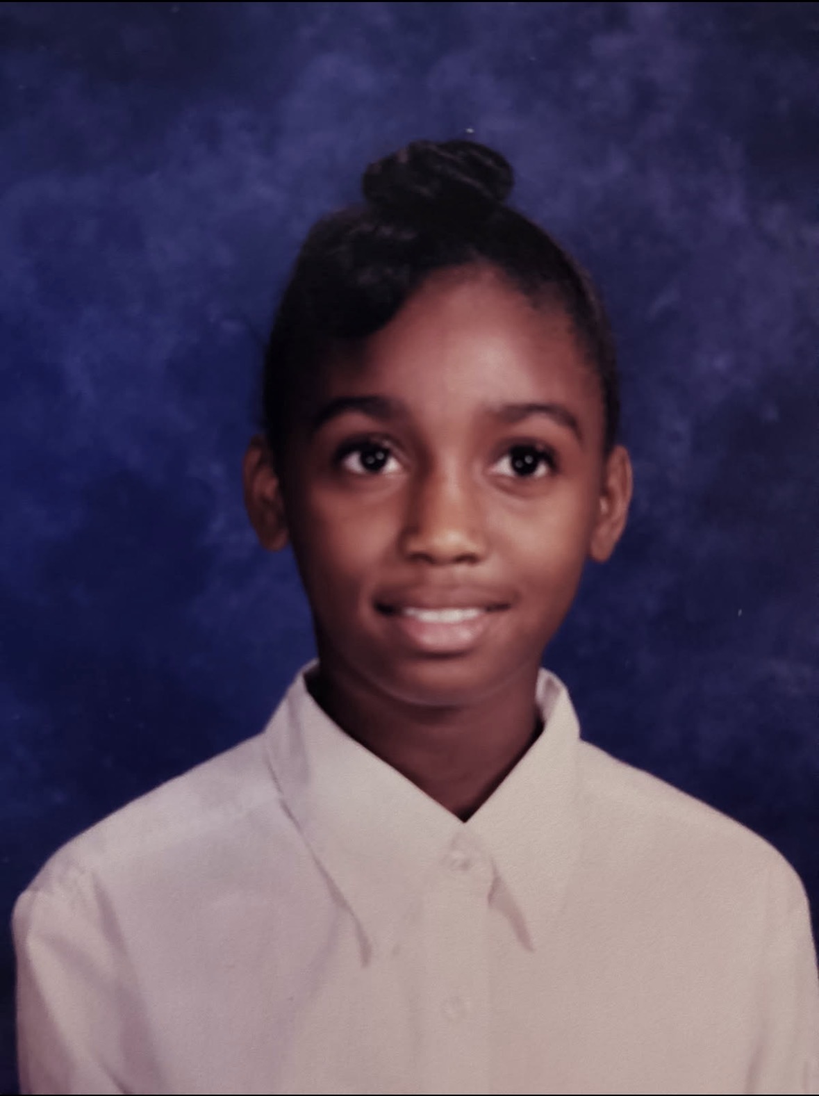 Young Makiebah in a childhood school portrait