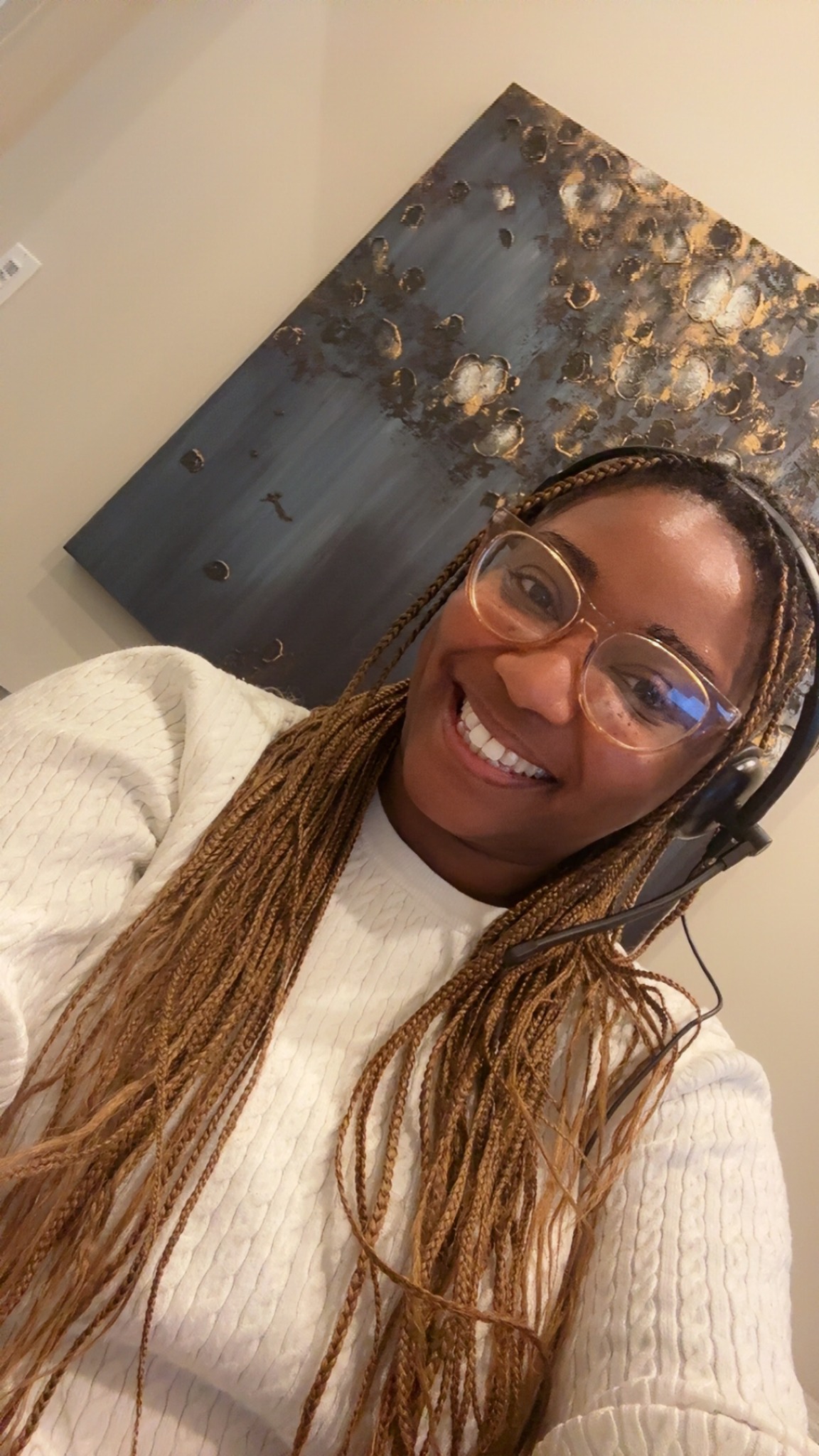 Makiebah smiling while working in her office